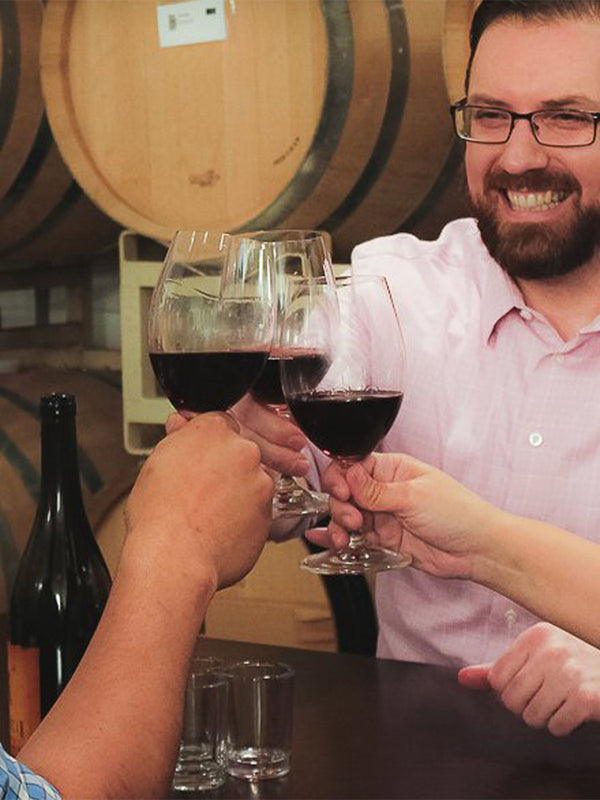 Wine Ventures Team Cheers in a barrel room