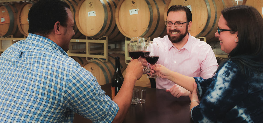 Wine Ventures Team Cheers in a barrel room